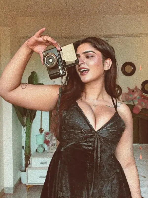 Vinni Varsha Chitara Flaunts Her Busty Curves In A Deep Neck Black Satin Dress